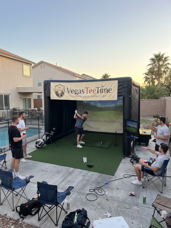 Friends at a bachelor party watching a guest swing at the Vegas Tee Time mobile golf simulator in a Las Vegas backyard by the pool