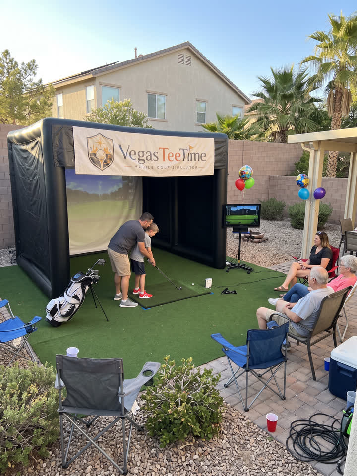 Dad helping his son swing at the Vegas Tee Time mobile golf simulator during a backyard birthday party in Henderson